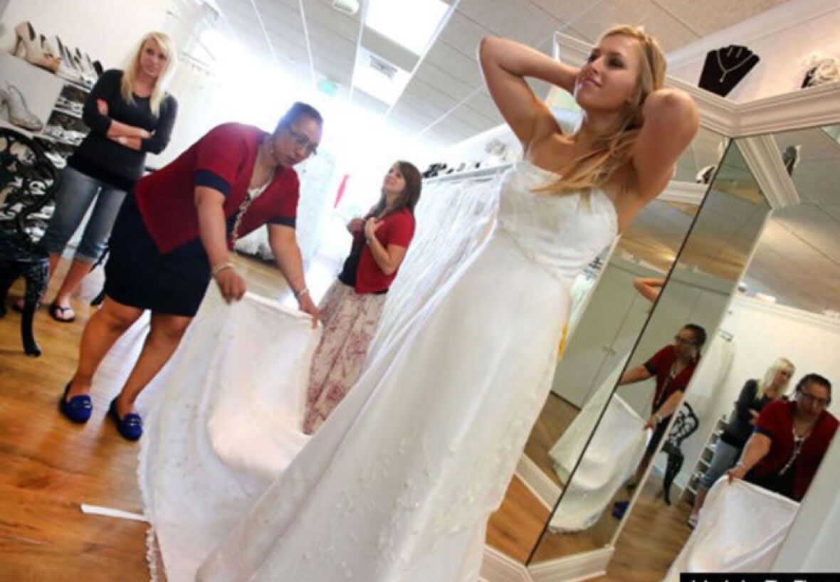 Bride-to-be trying on wedding dresses